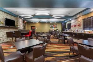 a restaurant with tables and chairs and a bar at Best Western Plus Sherwood Park Inn & Suites in Sherwood Park