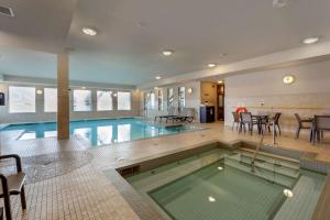 a swimming pool in a building with a swimming pool at Best Western Plus Sherwood Park Inn & Suites in Sherwood Park