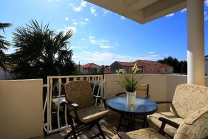 a patio with two chairs and a table on a balcony at Villa Sonja in Zadar