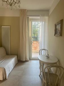 a bedroom with a bed and a table and a window at Bellaveduta Holidays Home in Baldissero Torinese