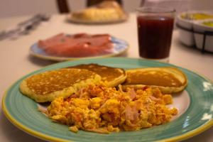 a plate of food with eggs and bread on a table at Hotel Dorado Plaza Calle del Arsenal in Cartagena de Indias