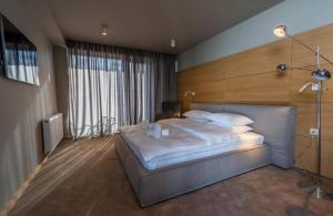 a bedroom with a large bed with a wooden headboard at New Gudauri Atrium in Gudauri