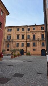 un gran edificio de ladrillo con puertas y ventanas en La Casetta di Zia Palmina, en Recanati