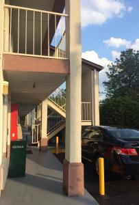 a car parked in a parking lot in front of a building at Knights Inn Augusta Fort Gordon in Augusta