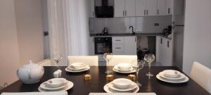 a dining room table with plates and wine glasses at Begonvil Konaklama in Sapanca