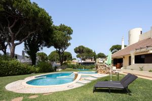 una piscina en un patio junto a una casa en Home Out - Big House - 8 Bedrooms, Heated Pool & Gym - Marina Vilamoura, en Vilamoura