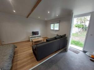 a living room with a couch and a table at Appartement indépendant 2 in Le Blanc-Mesnil
