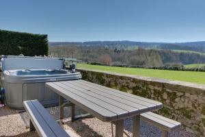a picnic table with a hot tub and a grill at Priesthill HotTub Pool Dog Friendly PeakDistrict in Stanton in Peak