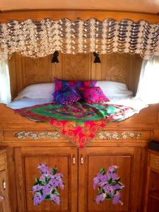 a bed with a quilt on top of it at Bungalow confortable à Saintes-Maries-de-la-Mer avec piscine in Saintes-Maries-de-la-Mer