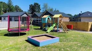 a playground with a slide and a swing set at Pastelowe Borne in Borne Sulinowo