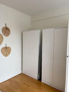 two white cabinets in a room with wood floors at Ruhig, zentral, Messe nah! BE3L in Essen