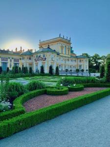 a large house with a garden in front of it at Luxurious Holiday Apartment in Warsaw in Warsaw