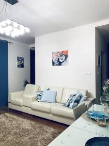 a living room with a couch and a table at Luxurious Holiday Apartment in Warsaw in Warsaw