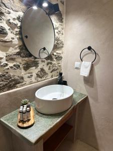 a bathroom with a sink and a mirror at Peristerionas Estate in Karistos