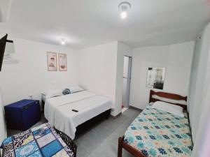 מיטה או מיטות בחדר ב-PRAIA DOS ANJOS - SUÍTEs