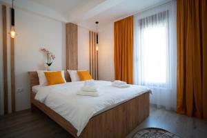 a bedroom with a large bed with towels on it at Apartments and rooms SMILE in Mostar