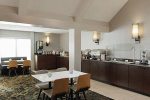 a kitchen and dining room with a table and chairs at Residence Inn by Marriott Boulder in Boulder