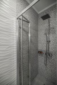 a shower with a glass door in a bathroom at Kiani Apts in Kalyves