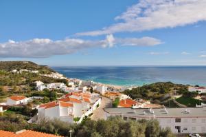 a view of a town with the ocean in the background at SALEMA - Amazing View Apartment in Salema