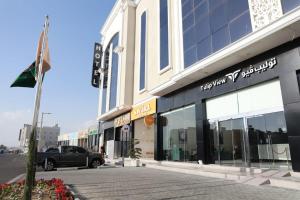 a building with a car parked in front of it at Tulip View Hotel in Khamis Mushayt