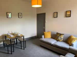a living room with a couch and a table at Balfour - Beautiful refurbished spacious 3 bedroom Gateshead flat in Gateshead