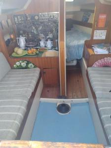 um pequeno quarto com uma cama e uma mesa num barco em super Voilier Eve em Gruissan
