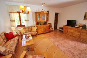 a living room with a couch and a tv at Monica II - holiday home with private swimming pool in Benissa in Benissa +6 photos