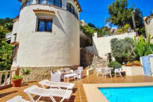 a villa with a swimming pool and a lighthouse at Monica II - holiday home with private swimming pool in Benissa in Benissa