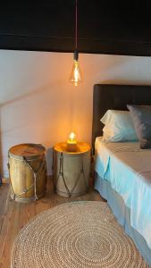 a bedroom with a bed and a table with a candle at LOFTS de FREIXAS in Pilar