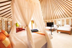 a bedroom with a bed with a mosquito net at Nusa Penida Yurt in Nusa Penida