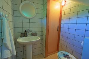 a bathroom with a sink and a mirror at Holiday House Klara in Otočac +22 photos