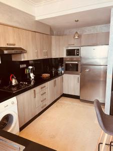 a kitchen with a stainless steel refrigerator and a dishwasher at Deluxe apartments in Casablanca +17 photos