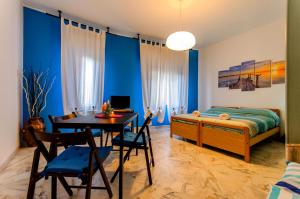 a bedroom with a bed and a table and chairs at Naxos Sea Holiday Apartments in Giardini Naxos