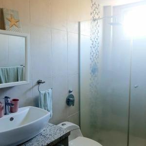 a bathroom with a shower and a toilet and a sink at Rio Mar Villages in San Carlos