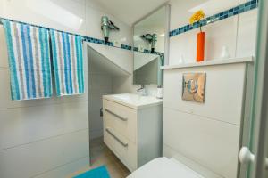 a white bathroom with a sink and a mirror at Apartmani Soldan in Makarska +115 photos
