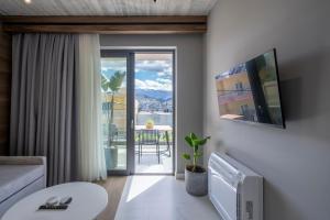 a living room with a couch and a table with a tv at Disegno Residences in Chania Town