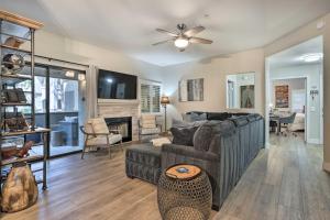 a living room with a couch and a table at Scottsdale Condo Pool, Hot Tub and Grill Access! in Scottsdale