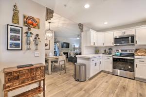 a kitchen with white cabinets and a dining room at Scottsdale Condo Pool, Hot Tub and Grill Access! in Scottsdale