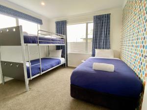a bedroom with two bunk beds and a window at Relax, Refresh, Recharge in Twizel