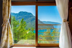 a window with a view of a mountain view at MANZARA BUNGALOW in Fethiye