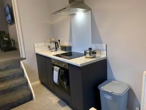 a small kitchen with a stove and a sink at Heaton-Beautiful 3 Double Bedrooms Sleeps 6 Free Parking and Wifi in Newcastle upon Tyne