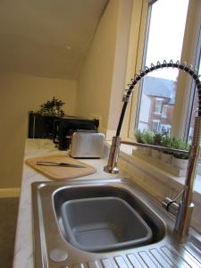 a kitchen counter with a sink and a window at Heaton-Beautiful 3 Double Bedrooms Sleeps 6 Free Parking and Wifi in Newcastle upon Tyne