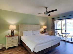 a bedroom with a large bed and a balcony at Edgewater Villa #2406 in Panama City Beach +18 photos