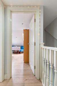 a hallway with a door leading to a dining room at Comfy Friendly Stay in London