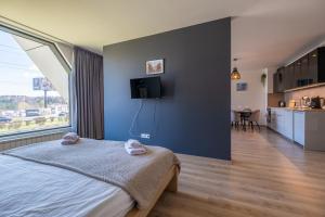 a bedroom with a bed and a tv on a wall at Arcadia Apartment, Park and Parking in Sofia