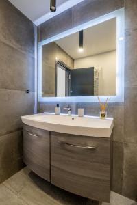a bathroom with a sink and a mirror at Arcadia Apartment, Park and Parking in Sofia