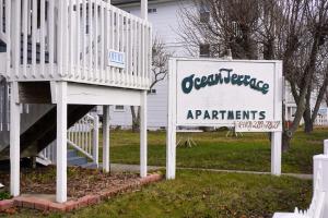 a sign for an apartment building and a sign for at Ocean Terrace Family Apartments in Ocean City