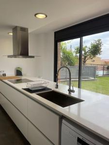 a kitchen with a sink and a large window at Casa para 8 personas en Berga - ALBERGA in Berga