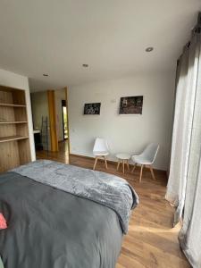 a bedroom with a bed and two chairs at Casa para 8 personas en Berga - ALBERGA in Berga