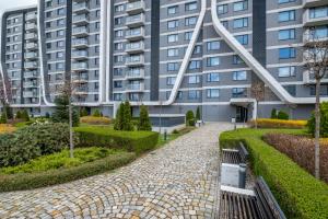 a building with a walkway in front of a building at Arcadia Apartment, Park and Parking in Sofia